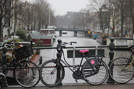 black bicycle beside black steel bar thumbnail