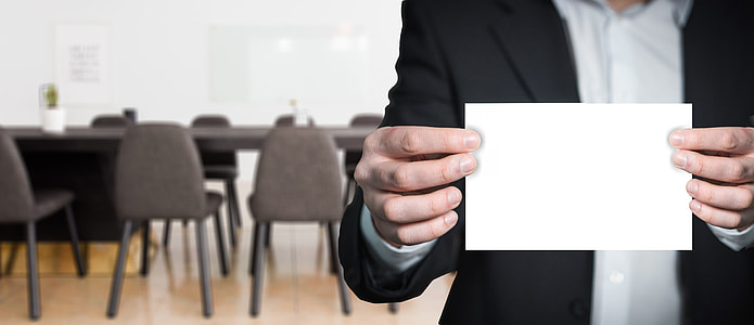 person holding white paper thumbnail