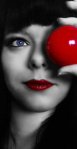 woman holding red ball in color selective photography thumbnail