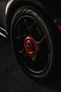red and black multi-spoke vehicle wheel with tire thumbnail