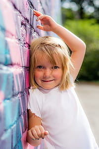 girl wearing white shirt lean on printed wall thumbnail