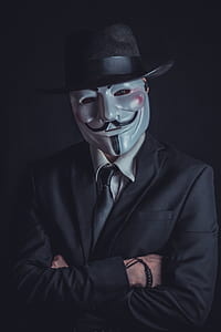 man wearing black suit jacket and guy fawkes guy thumbnail