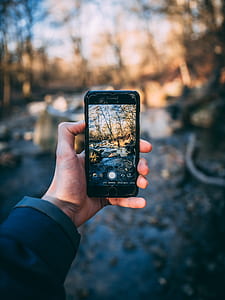 person holding post-2017 space gray iPhone thumbnail