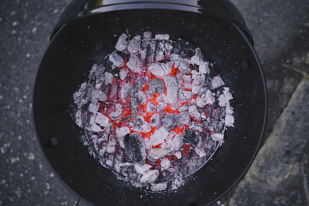 charcoal ember on black metal kettle grill thumbnail