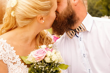 Kissing wedding couple in summer nature close-up portrait thumbnail