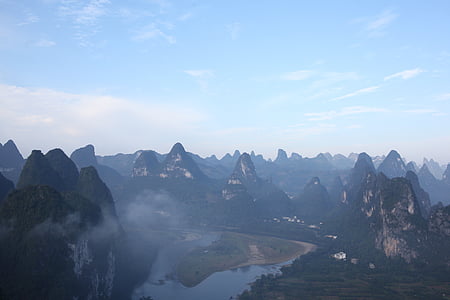 mountains near river during daytime thumbnail
