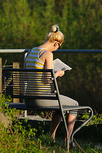 woman's reading newspaper during daytime thumbnail