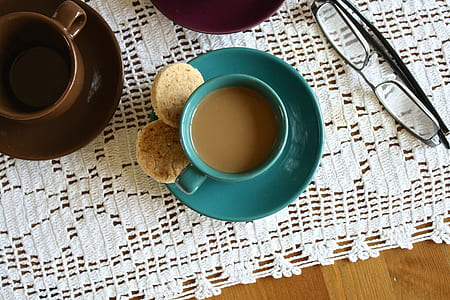 closeup photo of cup with brown liquid on white surface thumbnail