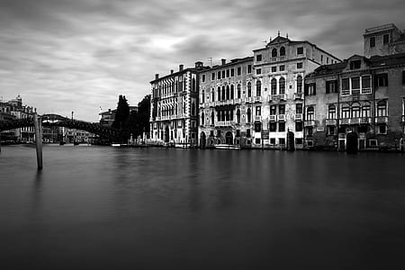 grayscale photography of town beside body of water thumbnail