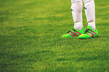 Feet and football boots of a male soccer player thumbnail