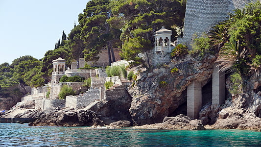 gray concrete structures beside sea thumbnail