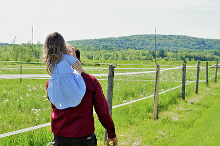 man carrying girl on his shoulder at daytime thumbnail