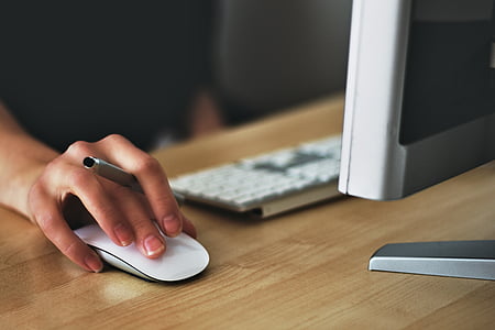 person holding white Apple Magic mouse thumbnail