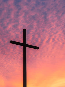 silhouette of cross taking photo during golden hour thumbnail