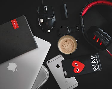 silver MacBook, corded gaming mouse, corded headphones and space gray iPhone 6s thumbnail