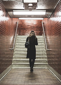 woman walking on brown ceramic floor tiles thumbnail