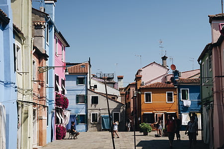 people standing between painted houses thumbnail