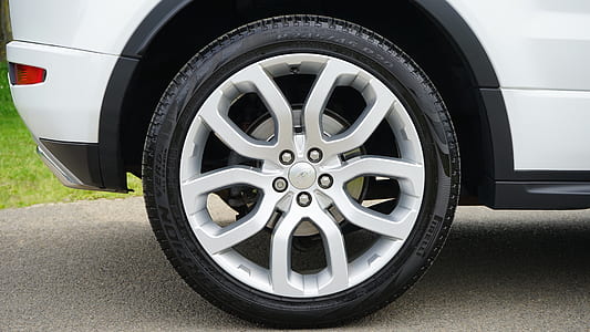 gray 5-spoked vehicle wheel with black tire thumbnail
