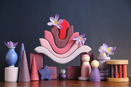 assorted-color wooden decoration on top of brown wooden surface thumbnail