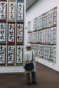 person watching at kanji printed signage hanged on walls thumbnail