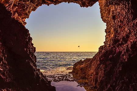 brown rock formation near sea thumbnail