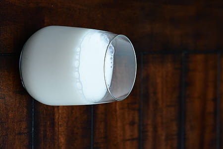 milk in stemless wine glass on table thumbnail