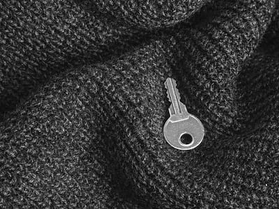 silver key on gray textile thumbnail