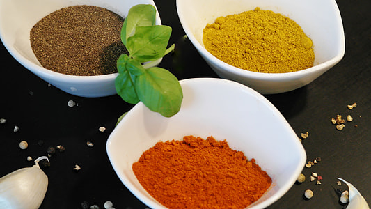 chili, ginger, and pepper powers on white ceramic bowls thumbnail