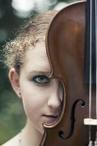shallow focus photography of woman face with violin thumbnail