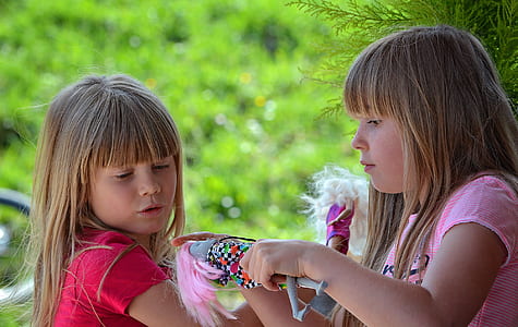 two girls playing dolls thumbnail