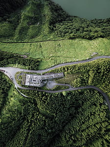aerial photo of gray building near body of water thumbnail