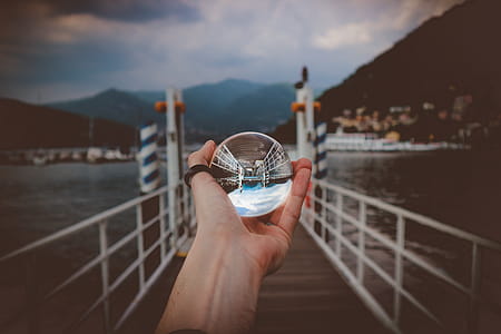 Person Holding Clear Glass Ball thumbnail