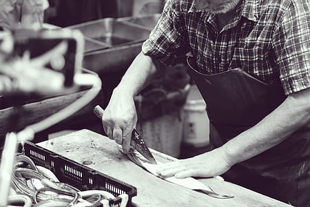 person standing beside workbench thumbnail