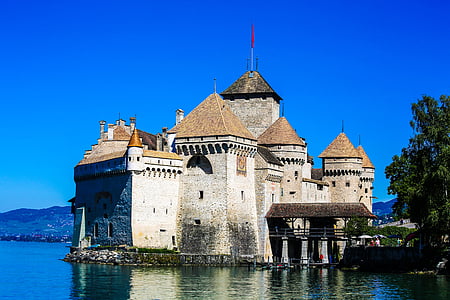brown concrete house on body of water thumbnail