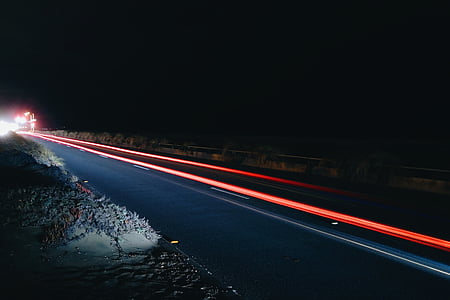speeding vehicles on road during night thumbnail
