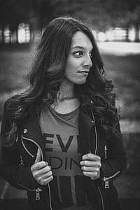 Woman Holding Her Jacket While Looking Sideway thumbnail
