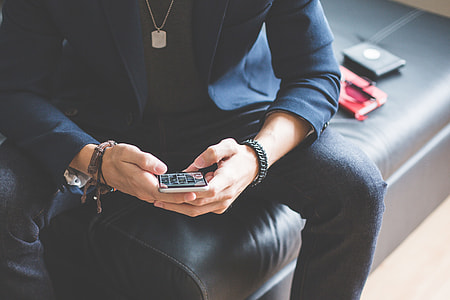 Man Using his iPhone 6 on a Sofa thumbnail