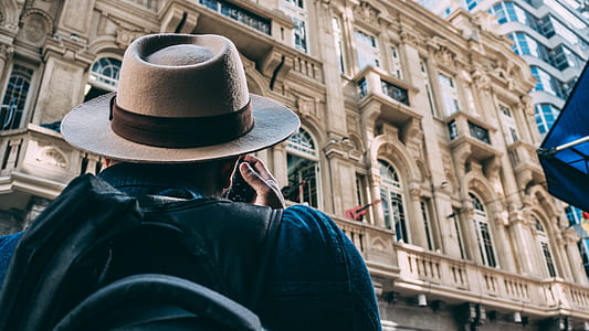 man taking picture on building thumbnail