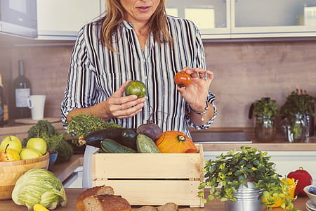 Woman with a pile of fresh vegetables in the kitchen thumbnail