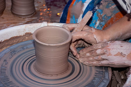 person making clay pot thumbnail