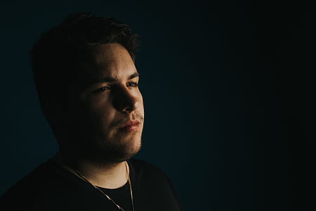 man wearing black crew-neck shirt looking faraway thumbnail
