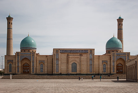 beige and teal mosque under white clouds thumbnail