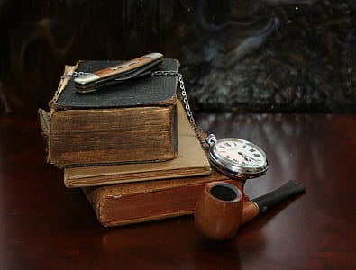 brown and black wooden pipe near books and pocket watch thumbnail