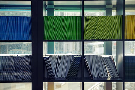 books piled in shelf thumbnail