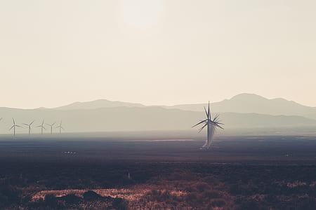 windmill near mountain at daytime thumbnail
