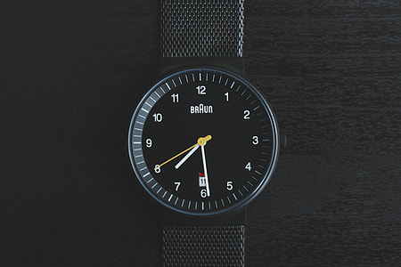 Overhead shot of black wrist watch thumbnail