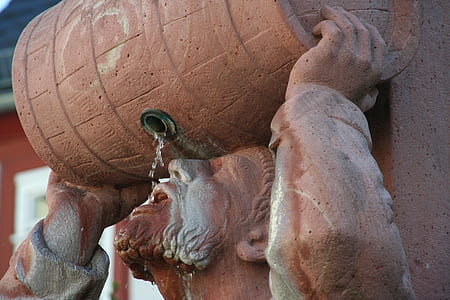 man drinking water from barrel statue thumbnail