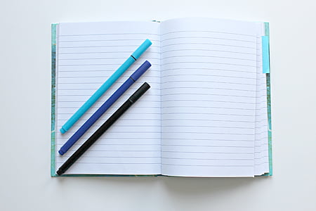 three color pens on top of notebook thumbnail