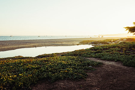 gray sand near ocean during sun set thumbnail