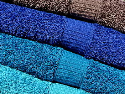assorted-color folded bath towels thumbnail